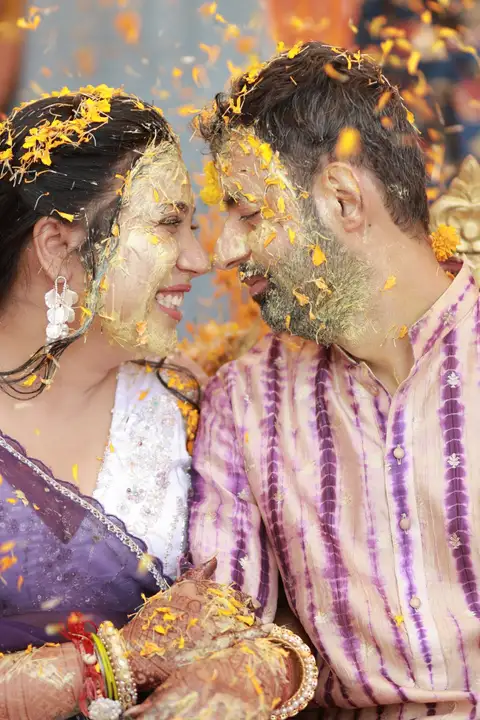 A bride and groom smiling at each other at their wedding celebrations